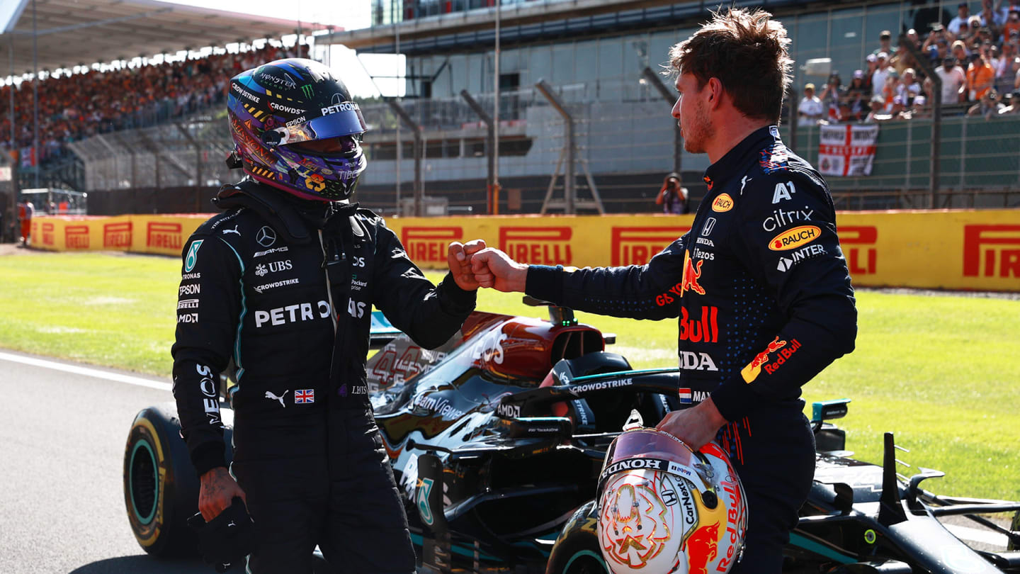 NORTHAMPTON, ENGLAND - JULY 17: Winner Max Verstappen of Netherlands and Red Bull Racing and second placed Lewis Hamilton of Great Britain and Mercedes GP bump fists in parc ferme during the Sprint for the F1 Grand Prix of Great Britain at Silverstone on July 17, 2021 in Northampton, England. (Photo by Mark Thompson/Getty Images)
