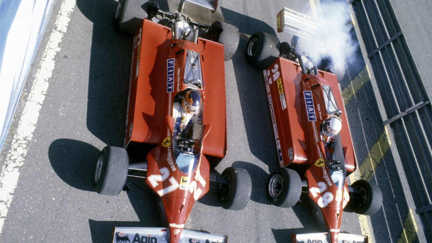 Gilles Villeneuve #27 and Didier Pironi #28 side by side in the pit lane aboard their Scuderia