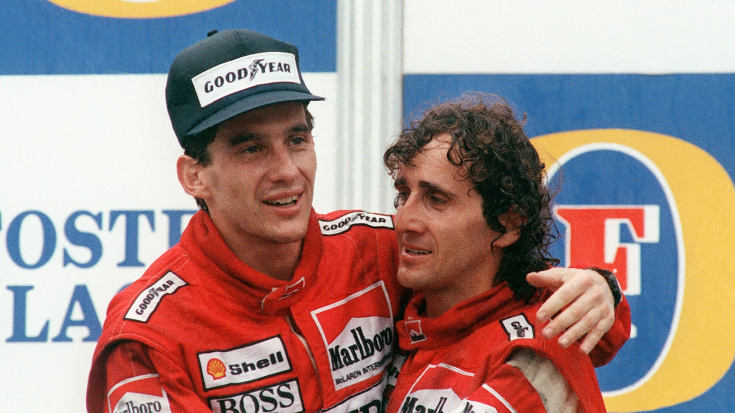 Brazilian new formula one champion Ayrton Senna (L) embraces his teammate and winner of today