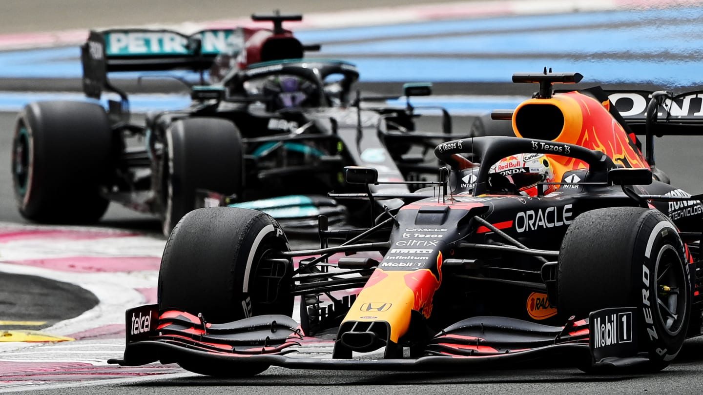 Red Bull's Dutch driver Max Verstappen drives ahead of Mercedes' British driver Lewis Hamilton