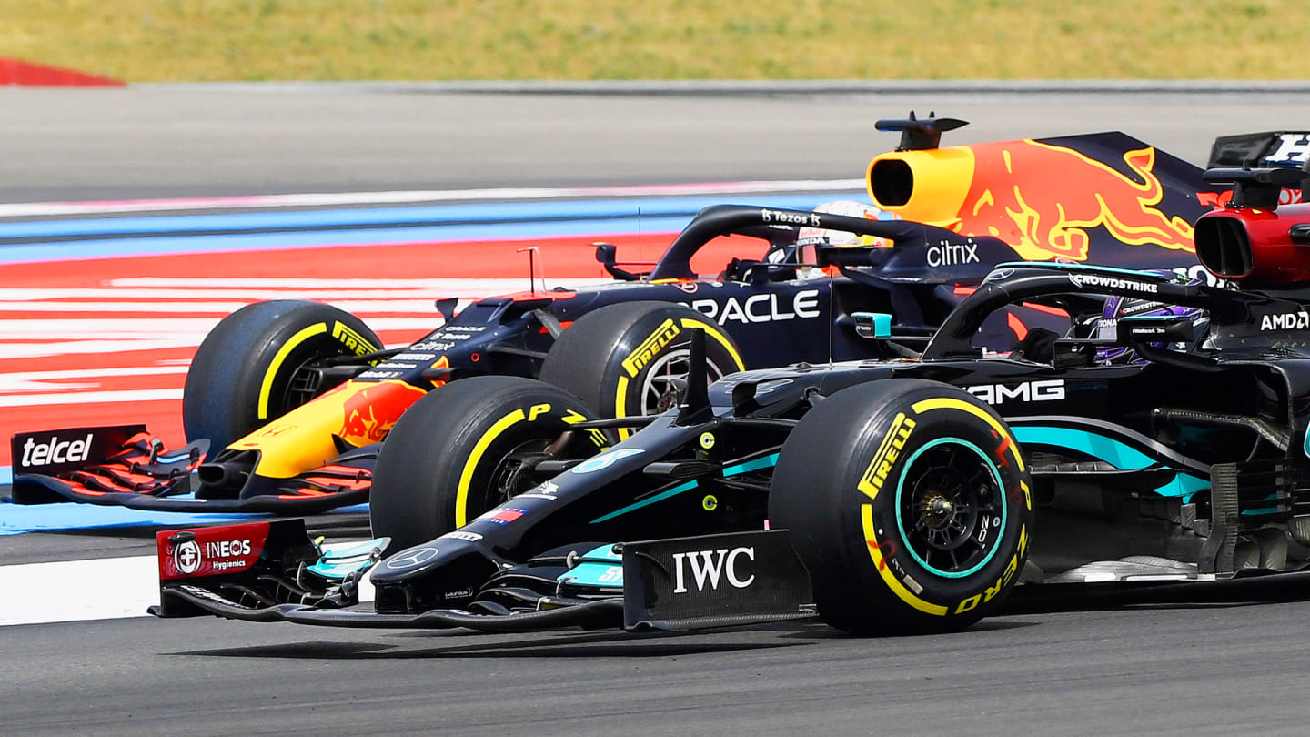 Mercedes' British driver Lewis Hamilton (R) drives past Red Bull's Dutch driver Max Verstappen at