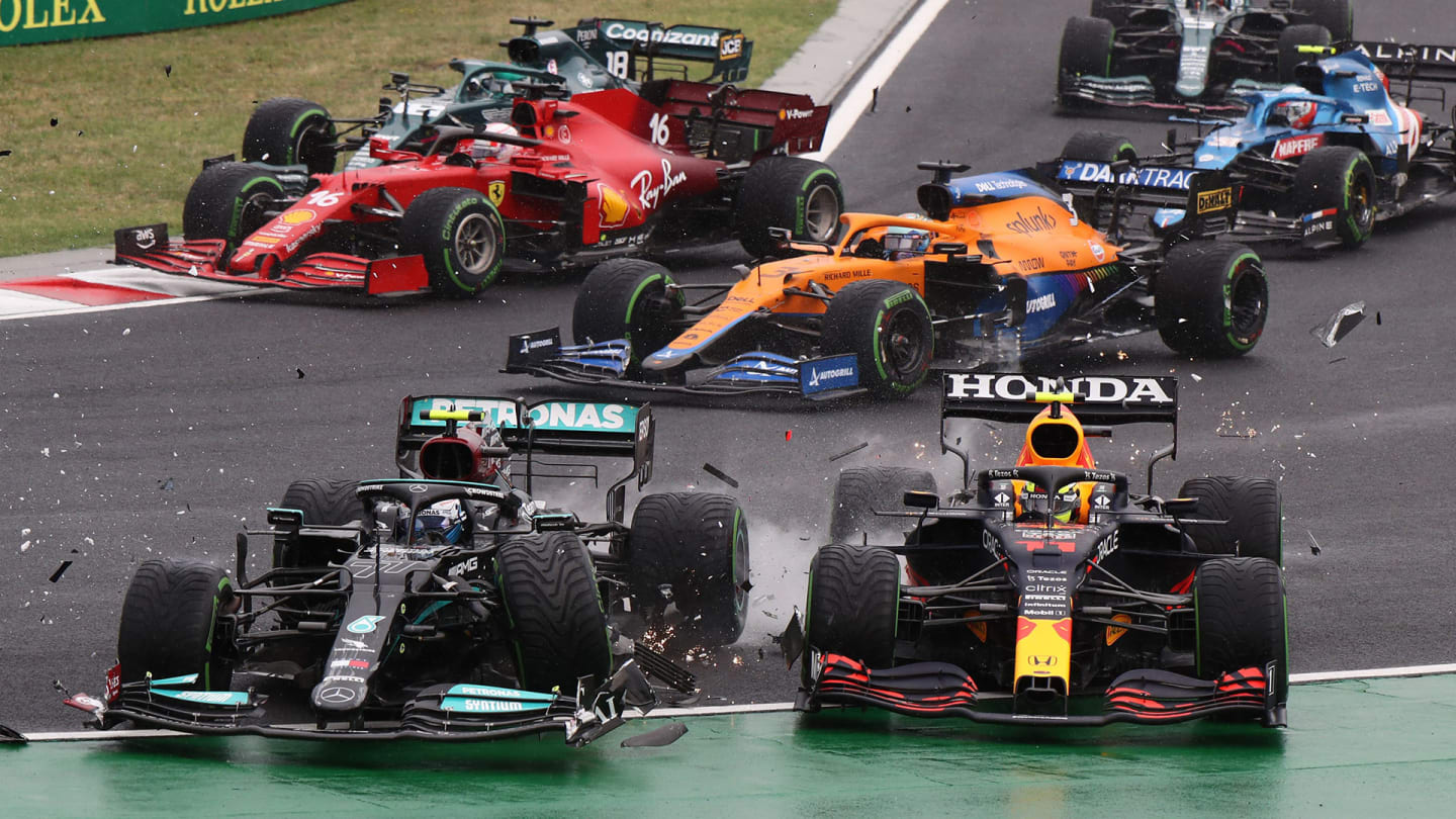 TOPSHOT - Mercedes' Finnish driver Valtteri Bottas collides with Red Bull's Mexican driver Sergio Perez during the Formula One Hungarian Grand Prix at the Hungaroring race track in Mogyorod near Budapest on August 1, 2021. (Photo by Peter Kohalmi / POOL / AFP) (Photo by PETER KOHALMI/POOL/AFP via Getty Images)
