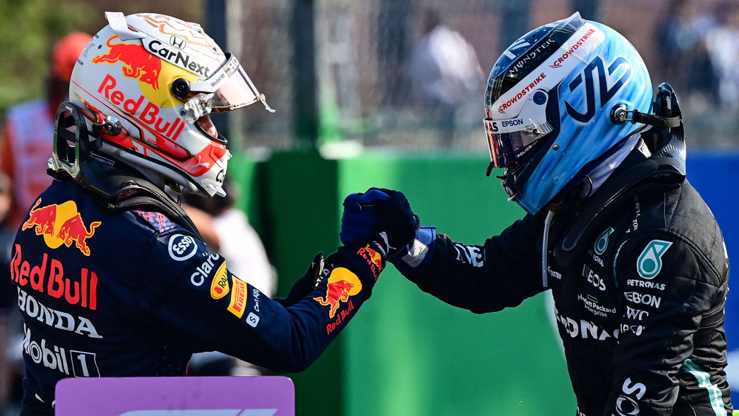 Mercedes' Finnish driver Valtteri Bottas (R) greets Red Bull's Dutch driver Max Verstappen (L)