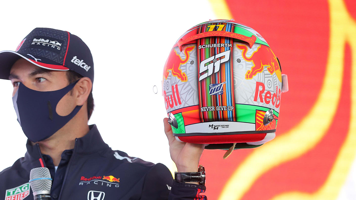 Perez holds up his special Mexico City GP helmet at a pre-race event
