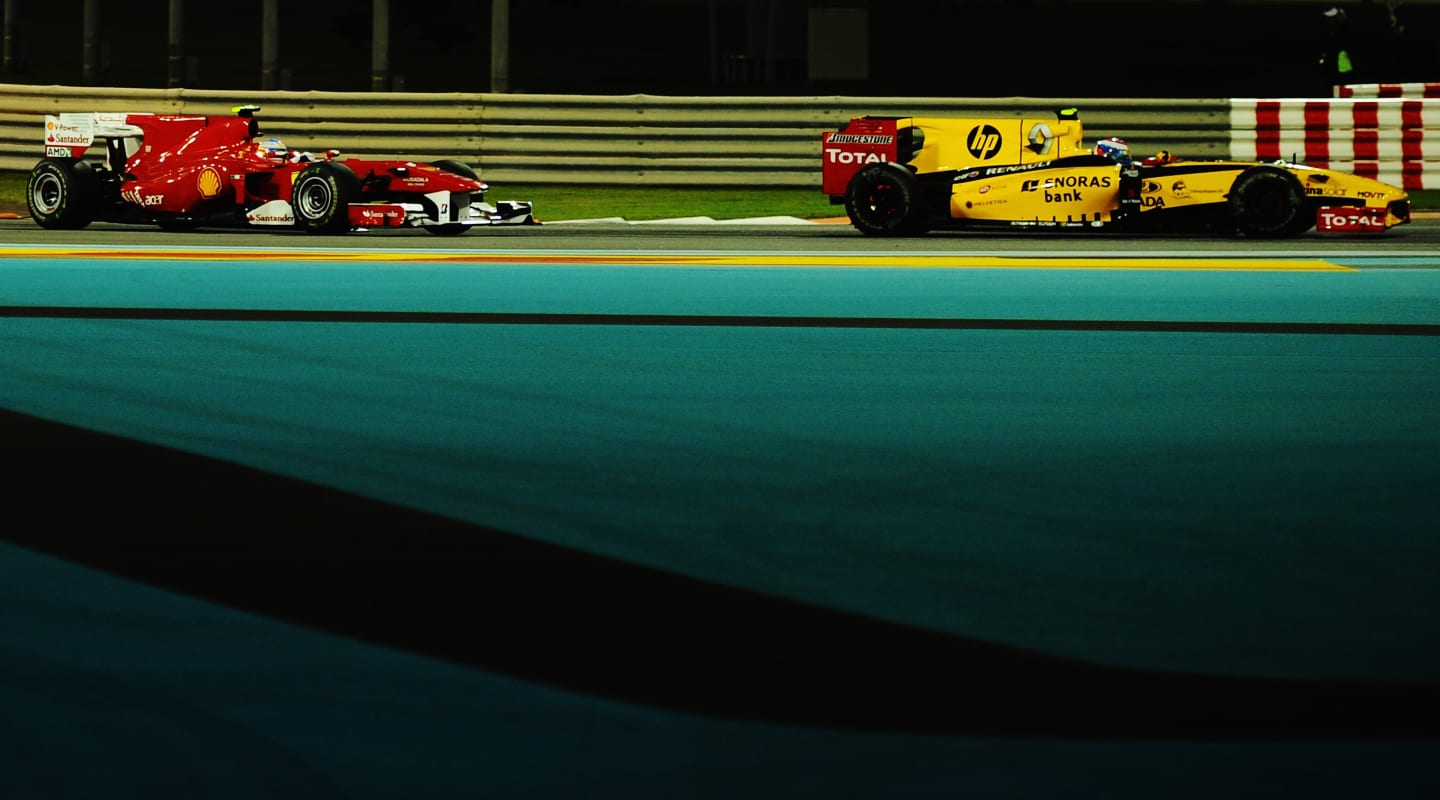 ABU DHABI, UNITED ARAB EMIRATES - NOVEMBER 14:  Vitaly Petrov of Russia and Renault leads from