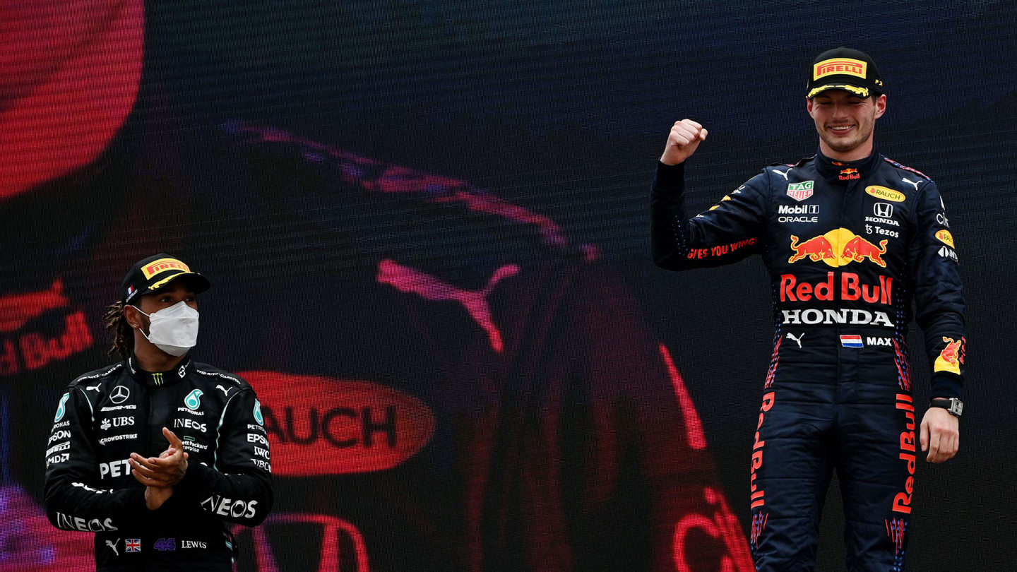Winner Red Bull's Dutch driver Max Verstappen celebrates as second-placed Mercedes' British driver