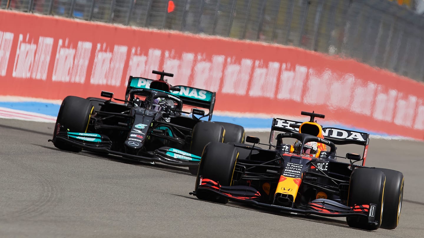 Max Verstappen of Netherlands driving the (33) Red Bull Racing RB16B Honda and Lewis Hamilton of