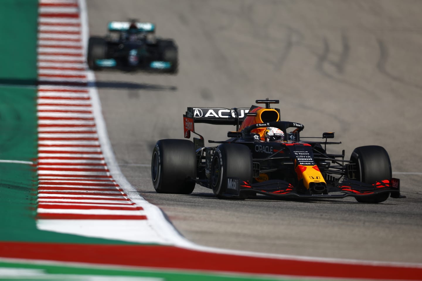 AUSTIN, TEXAS - OCTOBER 24: Max Verstappen of the Netherlands driving the (33) Red Bull Racing RB16B Honda leads Lewis Hamilton of Great Britain driving the (44) Mercedes AMG Petronas F1 Team Mercedes W12 during the F1 Grand Prix of USA at Circuit of The Americas on October 24, 2021 in Austin, Texas. (Photo by Jared C. Tilton/Getty Images)