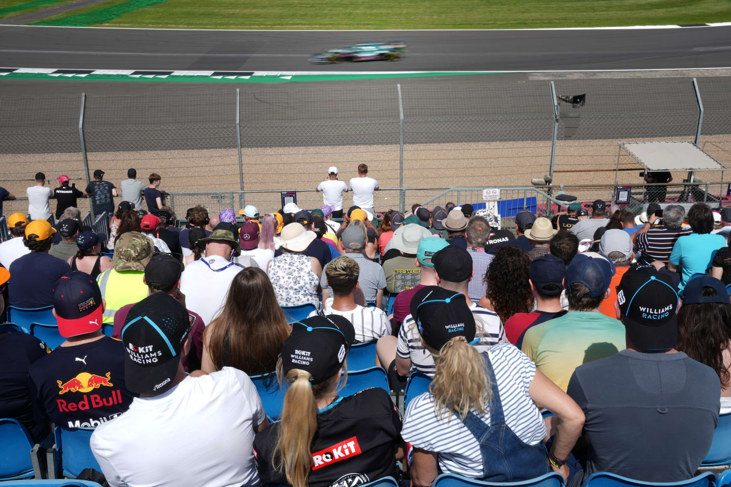 NORTHAMPTON, ENGLAND - JULY 16: Motor racing fans soak up the atmosphere during the practice run of