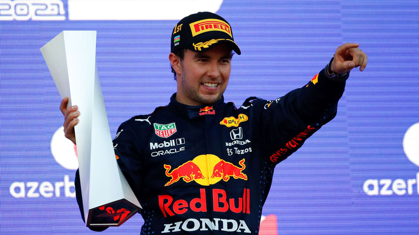 Red Bull's Mexican driver Sergio Perez celebrates on the podium after winning the Formula One