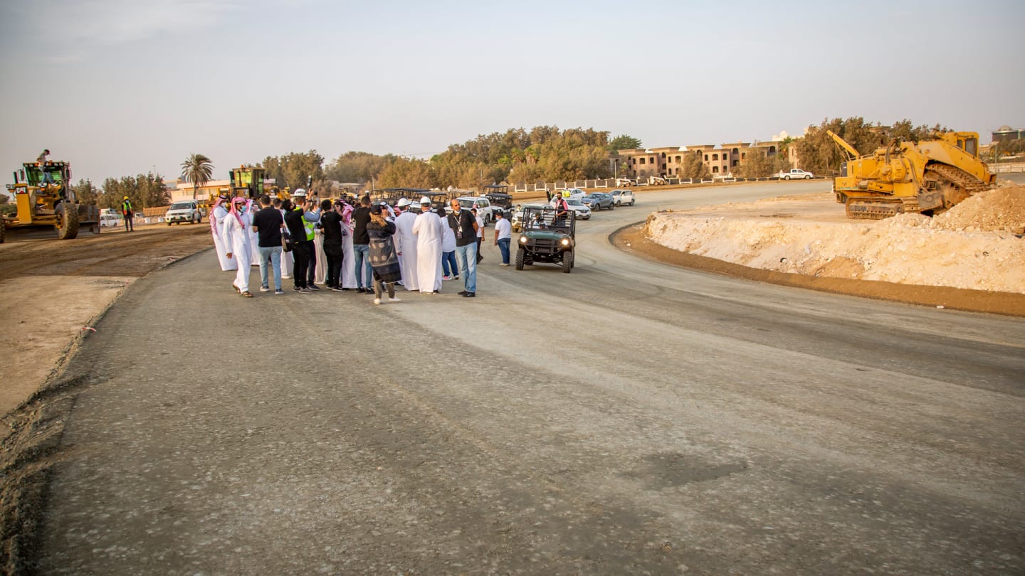 Another view of the banked Turn 13 corner at Jeddah, with media inspecting the site