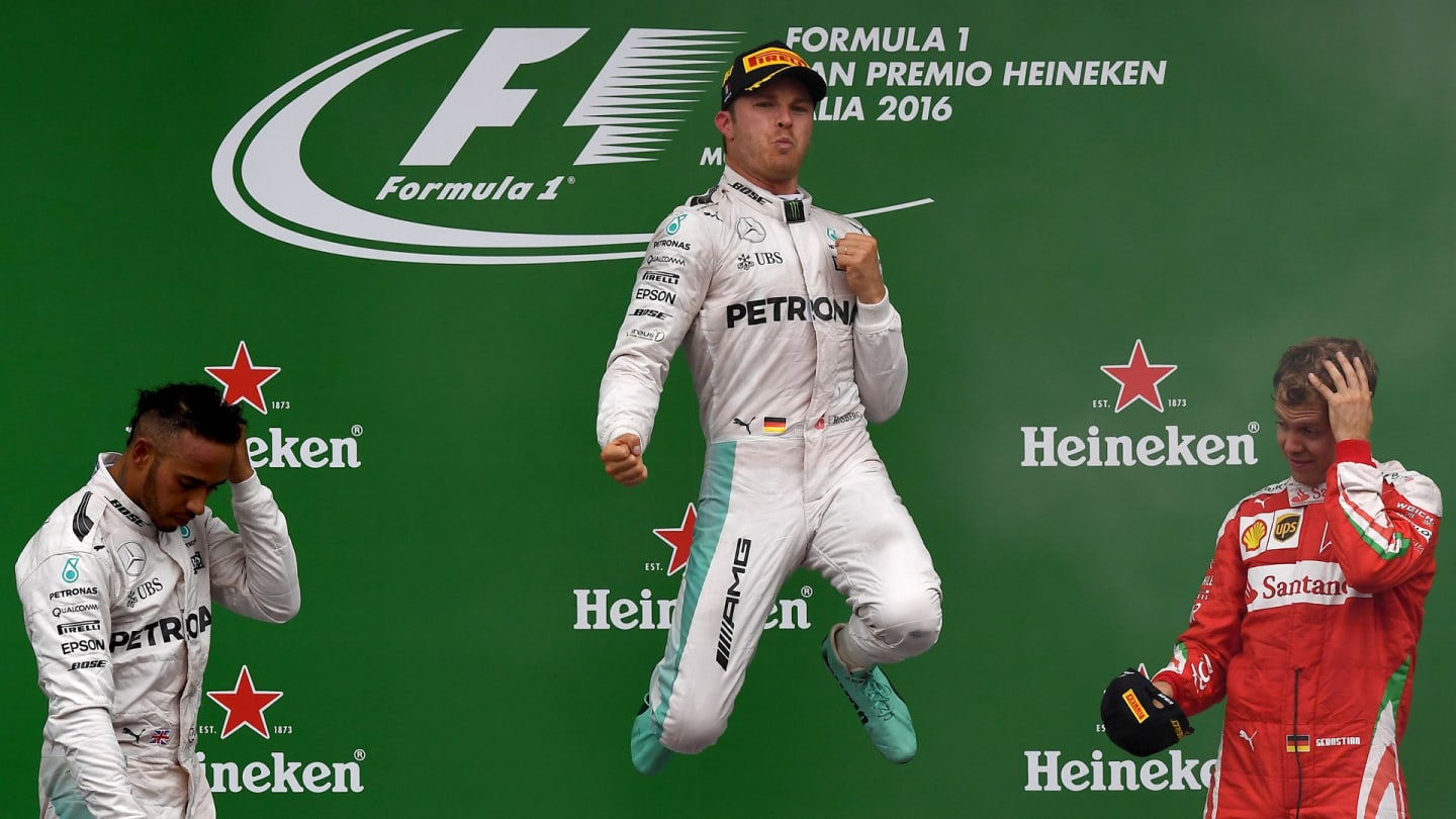TOPSHOT - Winner Mercedes AMG Petronas F1 Team's German driver Nico Rosberg (C) celebrates on the