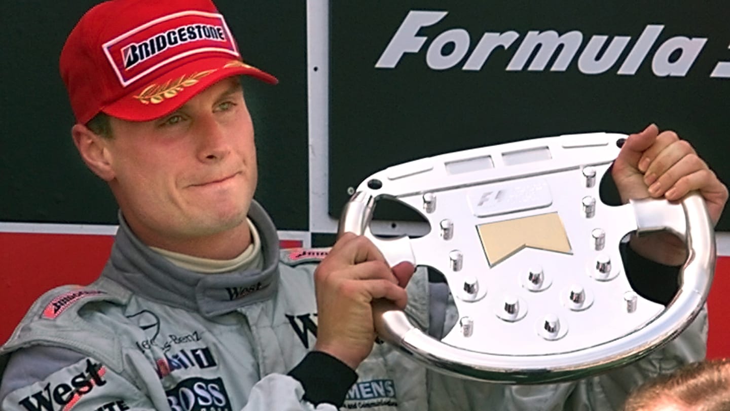 Scottish McLaren-Mercedes driver David Coulthard holds his trophy on the podium of the Montmelo