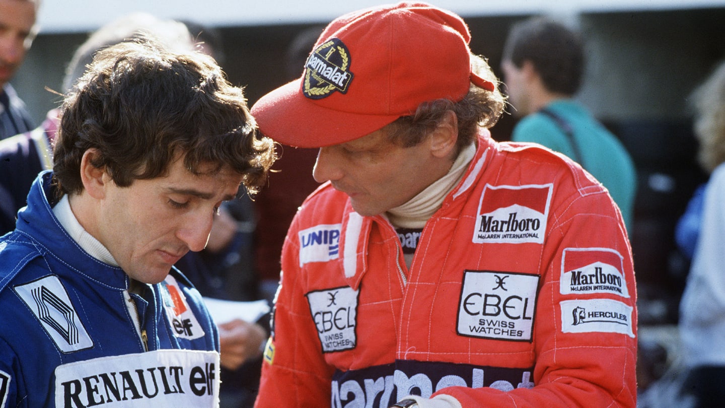 Austrian Formula One driver Niki Lauda (right) talks to French counterpart Alain Prost during the