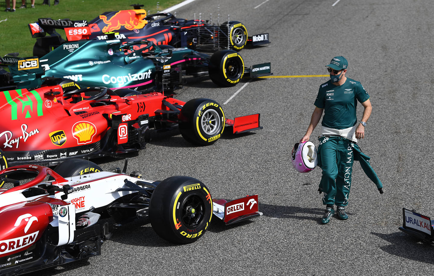 BAHRAIN, BAHRAIN - MARCH 12: Sebastian Vettel of Germany and Aston Martin walks amongst the cars on