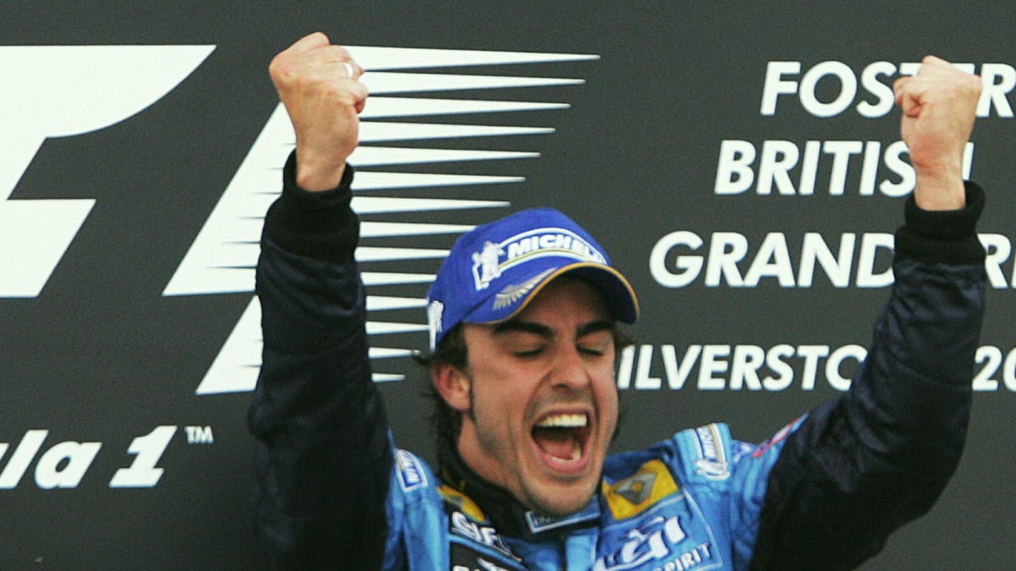Silverstone, UNITED KINGDOM:  Spanish Renault driver Fernando Alonso celebrates on the podium of