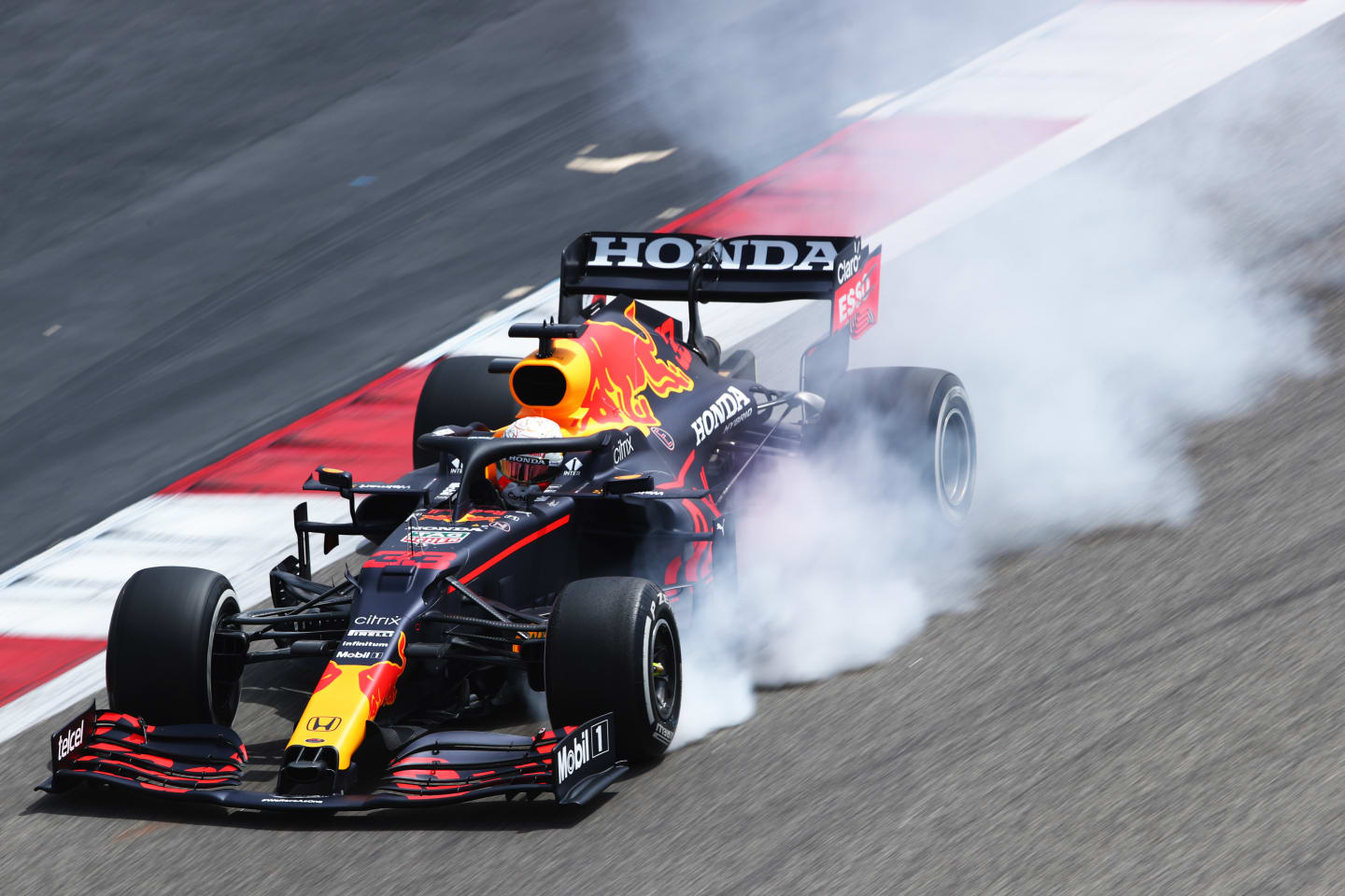A spectacular puff of smoke emitted by Verstappen's RB16B as he locks up