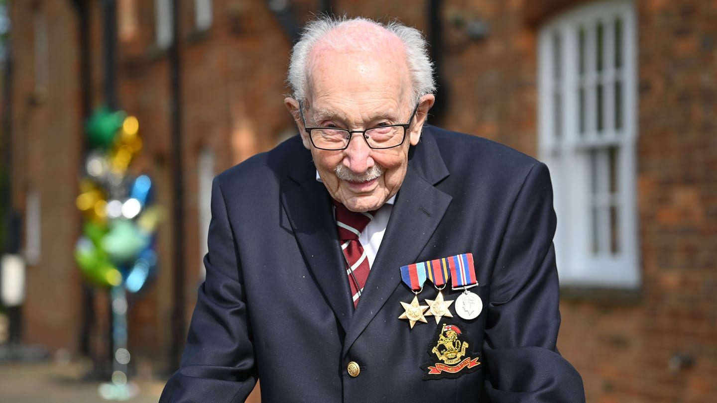 British World War II veteran Captain Tom Moore, 99, poses doing a lap of his garden in the village