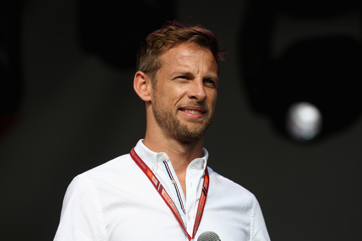 NORTHAMPTON, ENGLAND - JULY 07:  Former F1 driverJenson Button of Great Britain talks on the fan