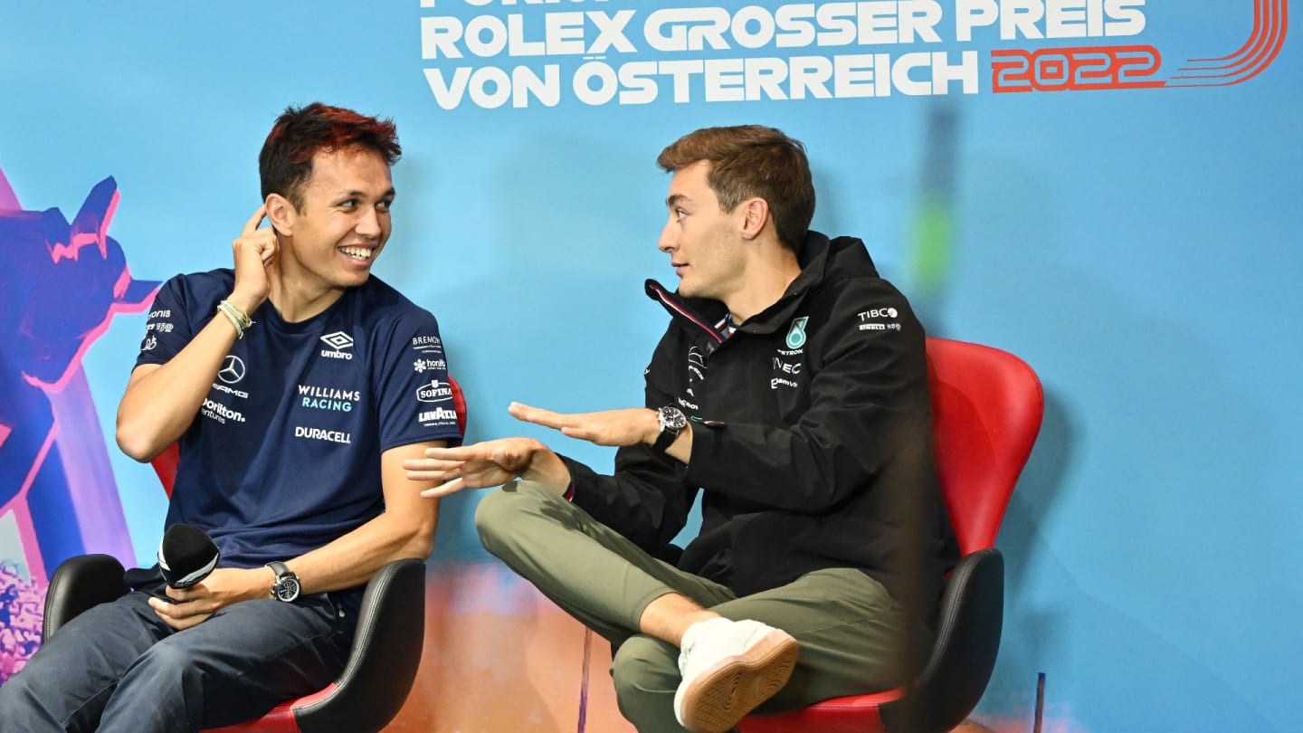 Williams' Thai driver Alexander Albon (L) and Mercedes' British driver George Russell chat during a press conference on July 7, 2022 prior to the Formula One Austrian Grand Prix in Spielberg, Austria. (Photo by Joe Klamar / AFP) (Photo by JOE KLAMAR/AFP via Getty Images)