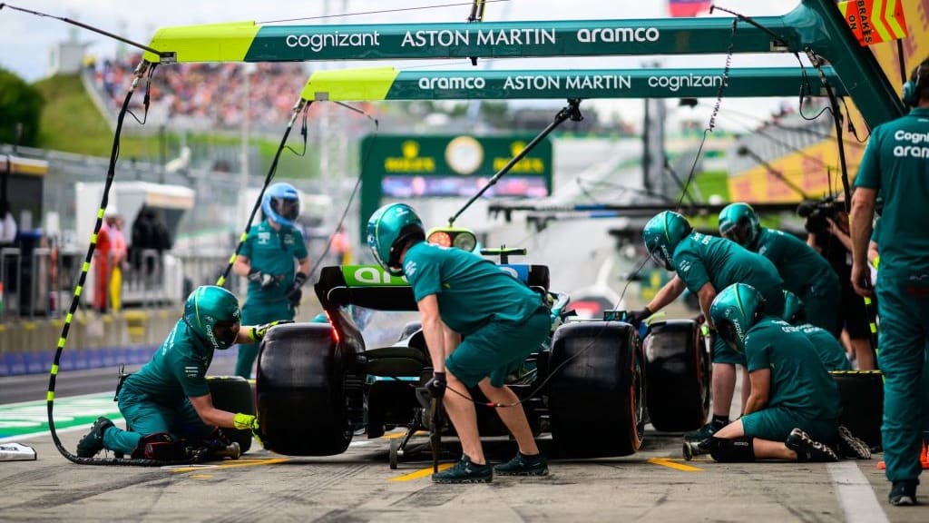 TOPSHOT - Aston Martin's German driver Sebastian Vettel arrives for a pit stop during the second