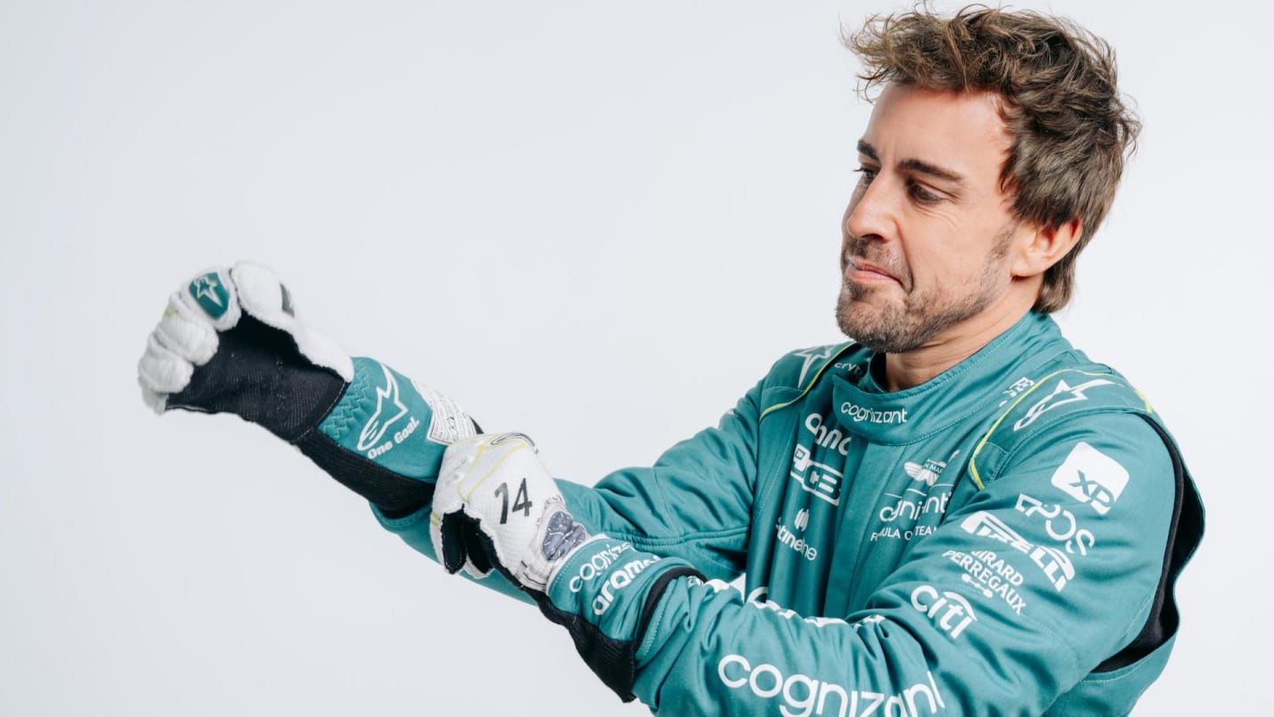 Fernando Alonso putting his race gloves on