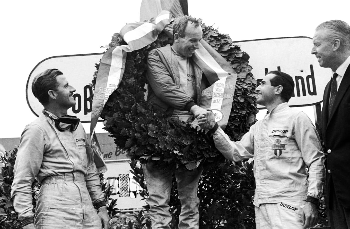 The podium (L to R): Graham Hill (GBR) BRM second; John Surtees (GBR) Ferrari winner; Lorenzo