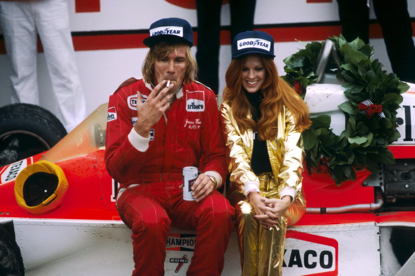 James Hunt (GBR) celebrates his win in Victory Lane with his McLaren M26, a cigarette, a beer, and