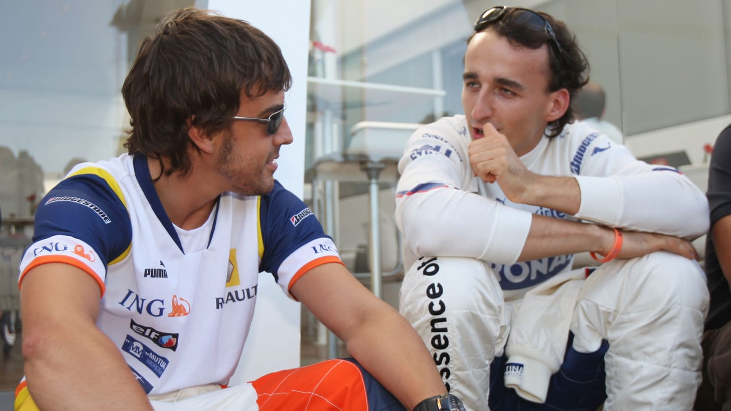 VALENCIA, SPAIN - AUGUST 21: Fernando Alonso of Spain and Renault talks to with fellow driver