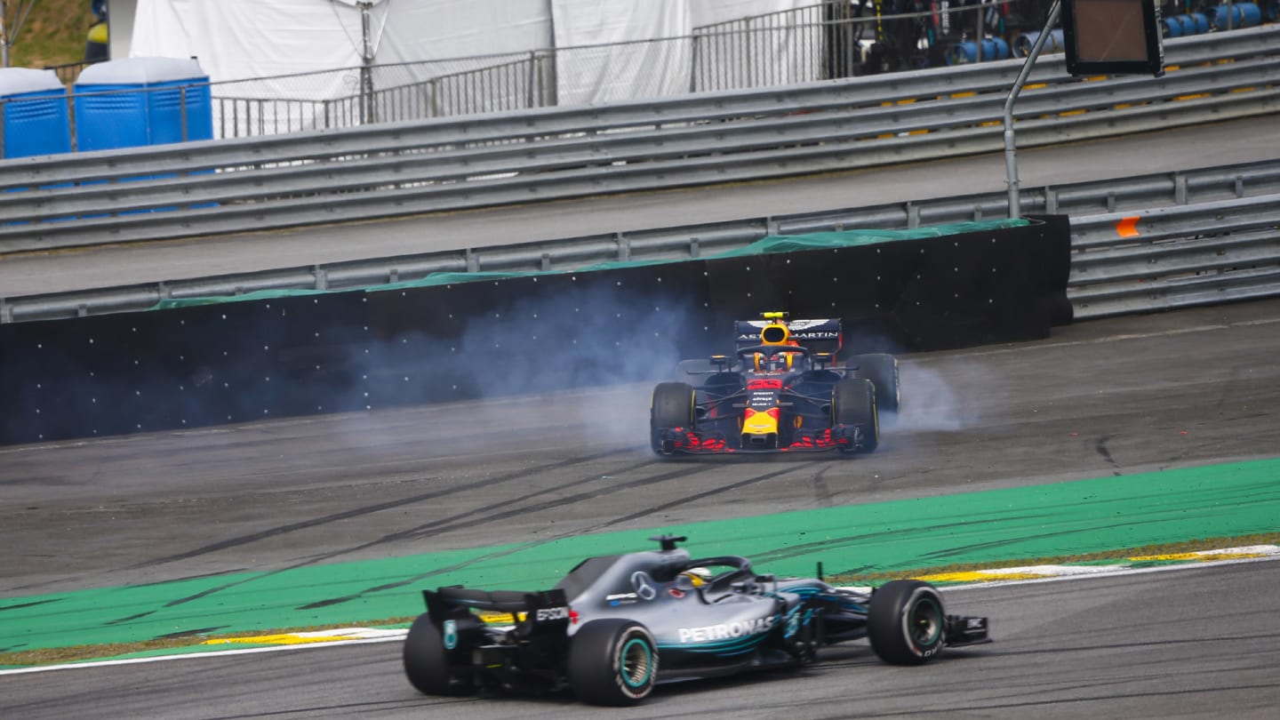 Lewis Hamilton, Mercedes AMG F1 W09, passes a spinning Max Verstappen, Red Bull Racing RB14 Tag Heuer, after the latter suffers a collision with Esteban Ocon, Force India VJM11 Mercedes during the Brazilian GP on November 11, 2018 in Autodromo Jose Carlos Pace, Brazil. (Photo by Andy Hone / LAT Images)