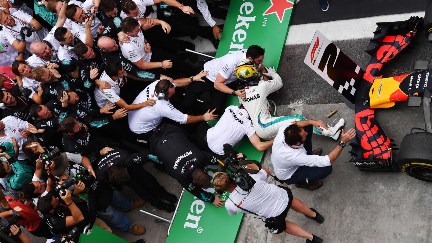 Barriers collapse as Lewis Hamilton, Mercedes AMG F1 celebrates with his mechanics in Parc Ferme during the Brazilian GP on November 11, 2018 in Autodromo Jose Carlos Pace, Brazil. (Photo by Jerry Andre / Sutton Images)