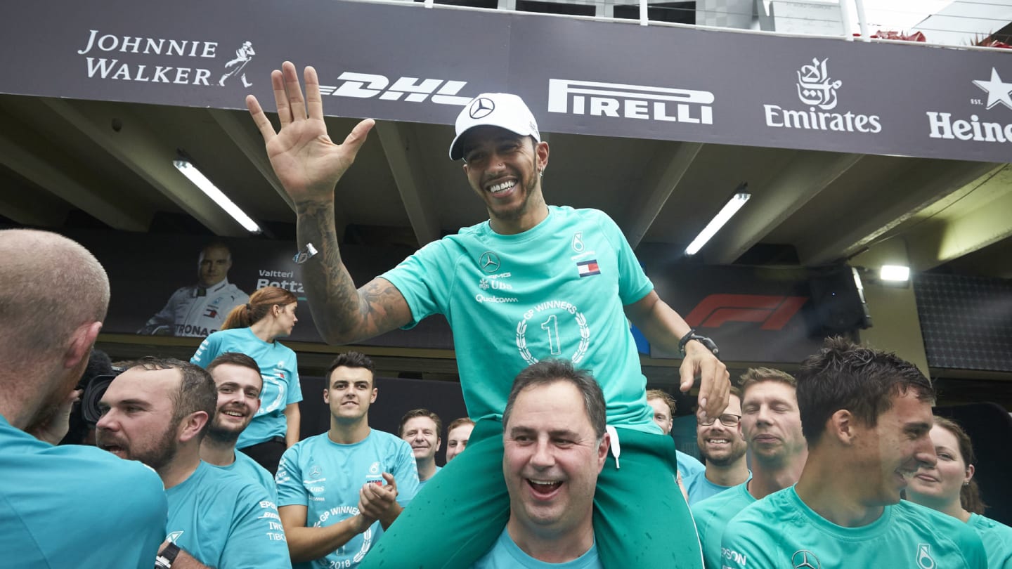 Lewis Hamilton, Mercedes AMG F1, on the shoulders of Ron Meadows, Sporting Director, Mercedes AMG, celebrates with the Mercedes team during the Brazilian GP at Autódromo José Carlos Pace on November 11, 2018. (Photo by Steve Etherington / LAT Images)