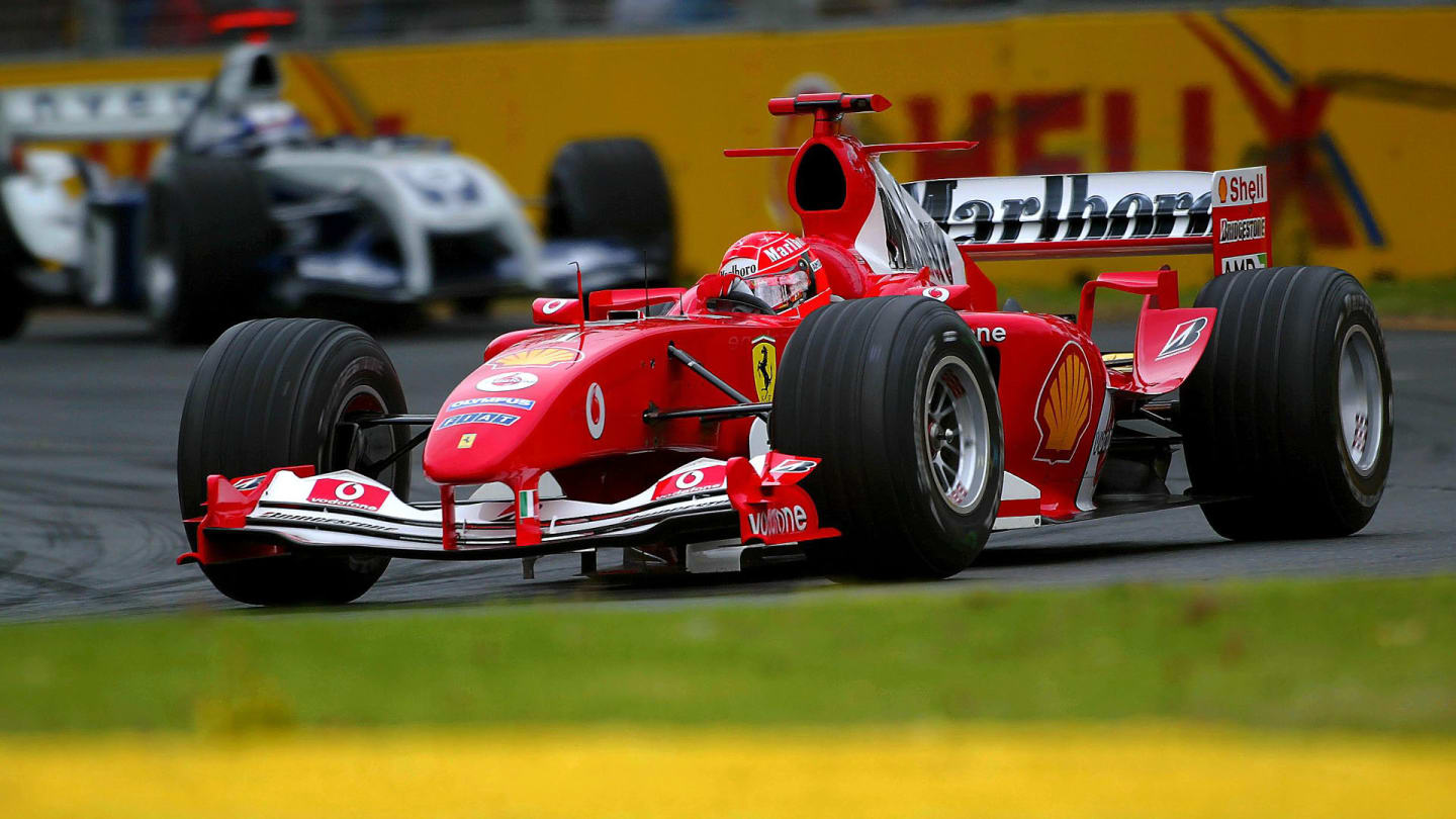 Michael Schumacher (GER) Ferrari F2004 leads Juan Pablo Montoya (COL) Williams BMW FW26.
Formula