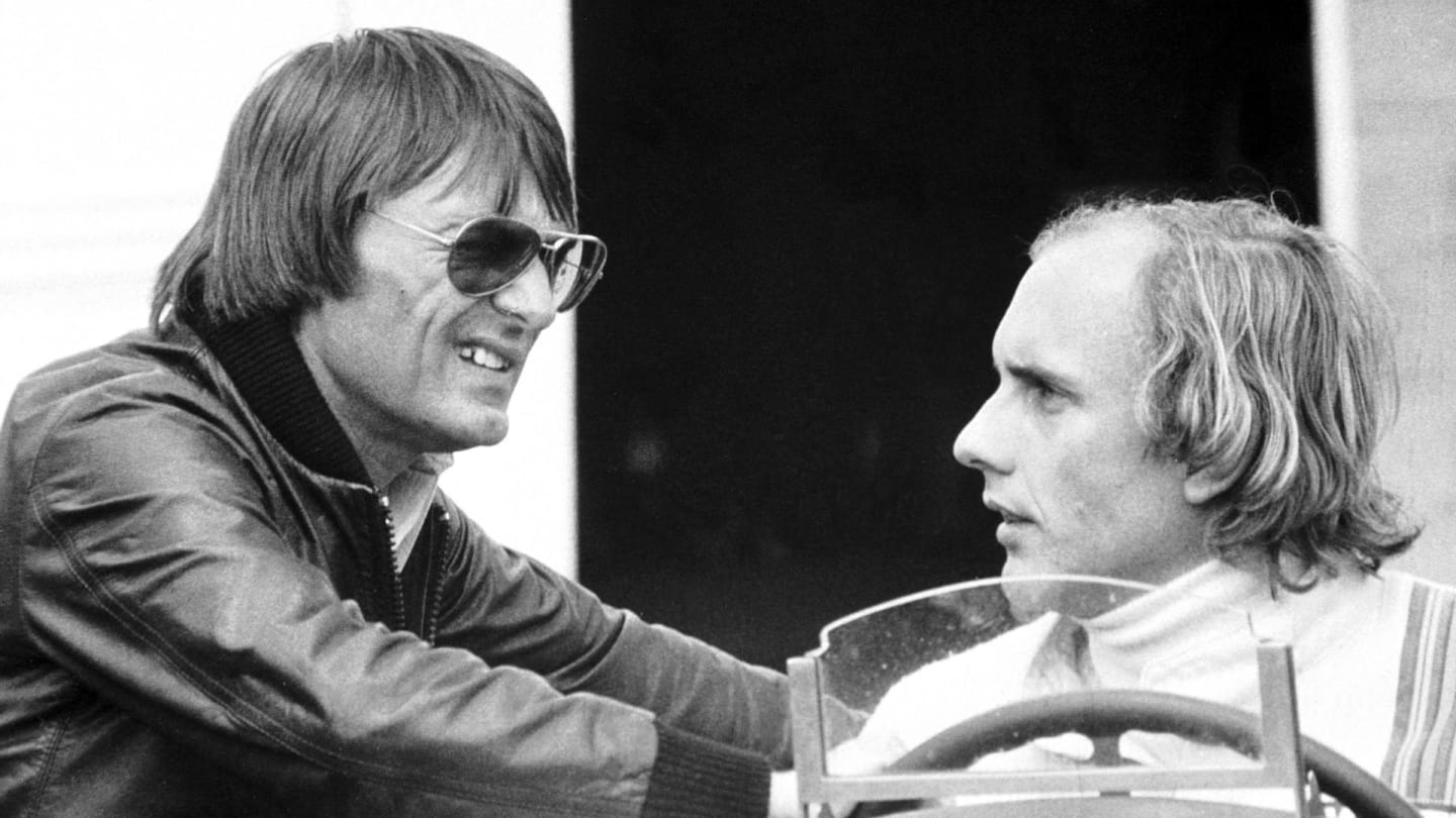 Seen here chatting with Brabham team owner Bernie Ecclestone at Silverstone, Stuck finished the 1977 British Grand Prix in fifth place