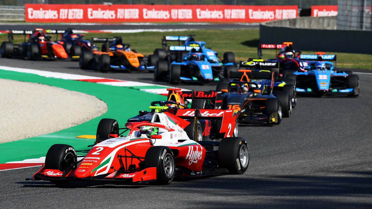 SCARPERIA, ITALY - SEPTEMBER 13: Frederik Vesti of Denmark and Prema Racing (2) leads Dennis Hauger