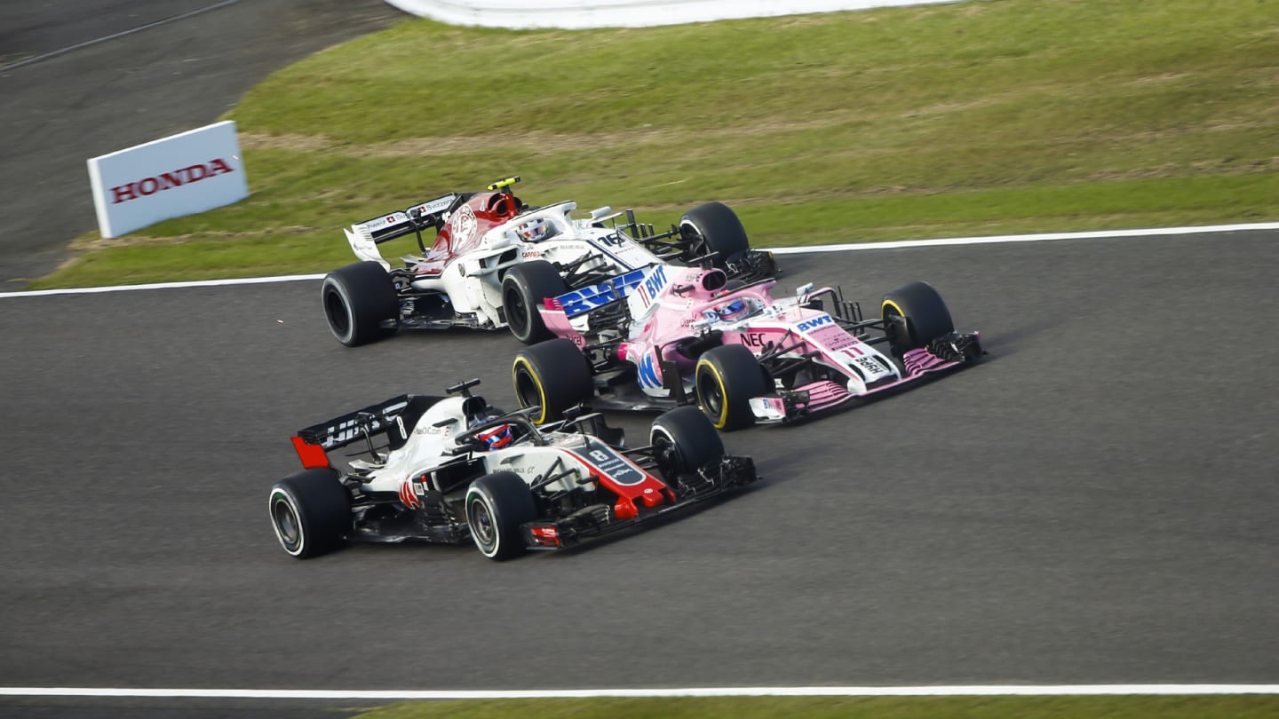 SUZUKA, JAPAN - OCTOBER 07: Romain Grosjean, Haas F1 Team VF-18, battles with Sergio Perez, Racing Point Force India VJM11 and Charles Leclerc, Sauber C37 Ferrari during the Japanese GP at Suzuka on October 07, 2018 in Suzuka, Japan. (Photo by Andy Hone / LAT Images)