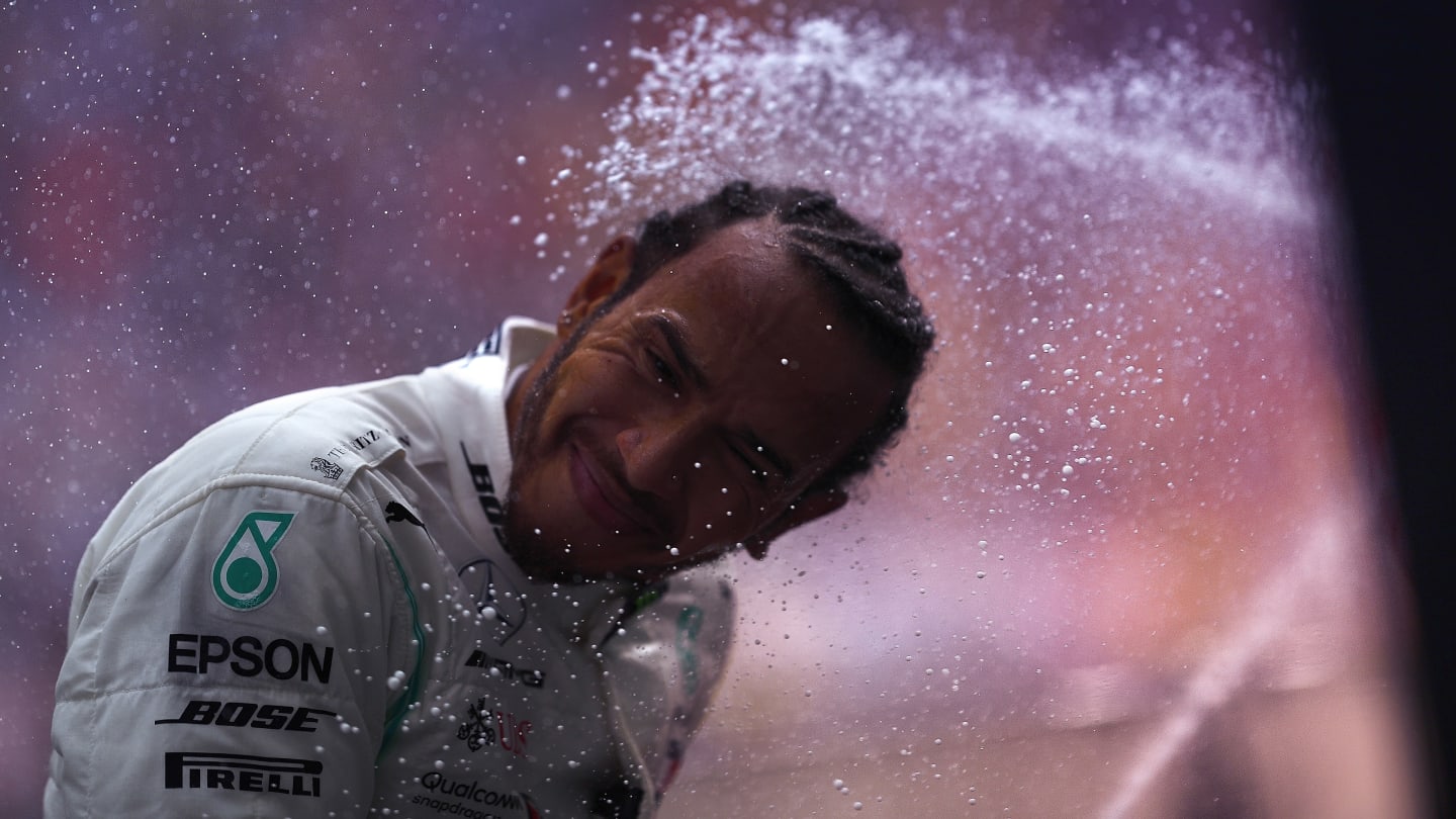 Winner Lewis Hamilton is showered in champagne on the China podium. Image: Mario Renzi