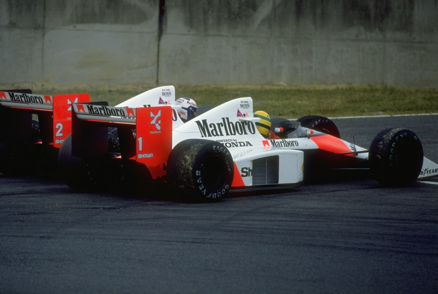 1989:  Alain Prost of France and Ayrton Senna of Brazil collide in their McLaren Hondas during the