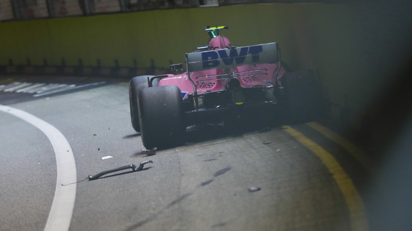 SINGAPORE STREET CIRCUIT, SINGAPORE - SEPTEMBER 16: Esteban Ocon, Racing Point Force India VJM11, crashes out after contact with his team mate at the start during the Singapore GP at Singapore Street Circuit on September 16, 2018 in Singapore Street Circuit, Singapore. (Photo by Zak Mauger / LAT Images)