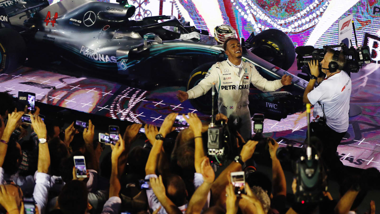 SINGAPORE STREET CIRCUIT, SINGAPORE - SEPTEMBER 16: Lewis Hamilton, Mercedes AMG F1 W09 EQ Power+, celebrates in Parc Ferme after winning the race during the Singapore GP at Singapore Street Circuit on September 16, 2018 in Singapore Street Circuit, Singapore. (Photo by Zak Mauger / LAT Images)