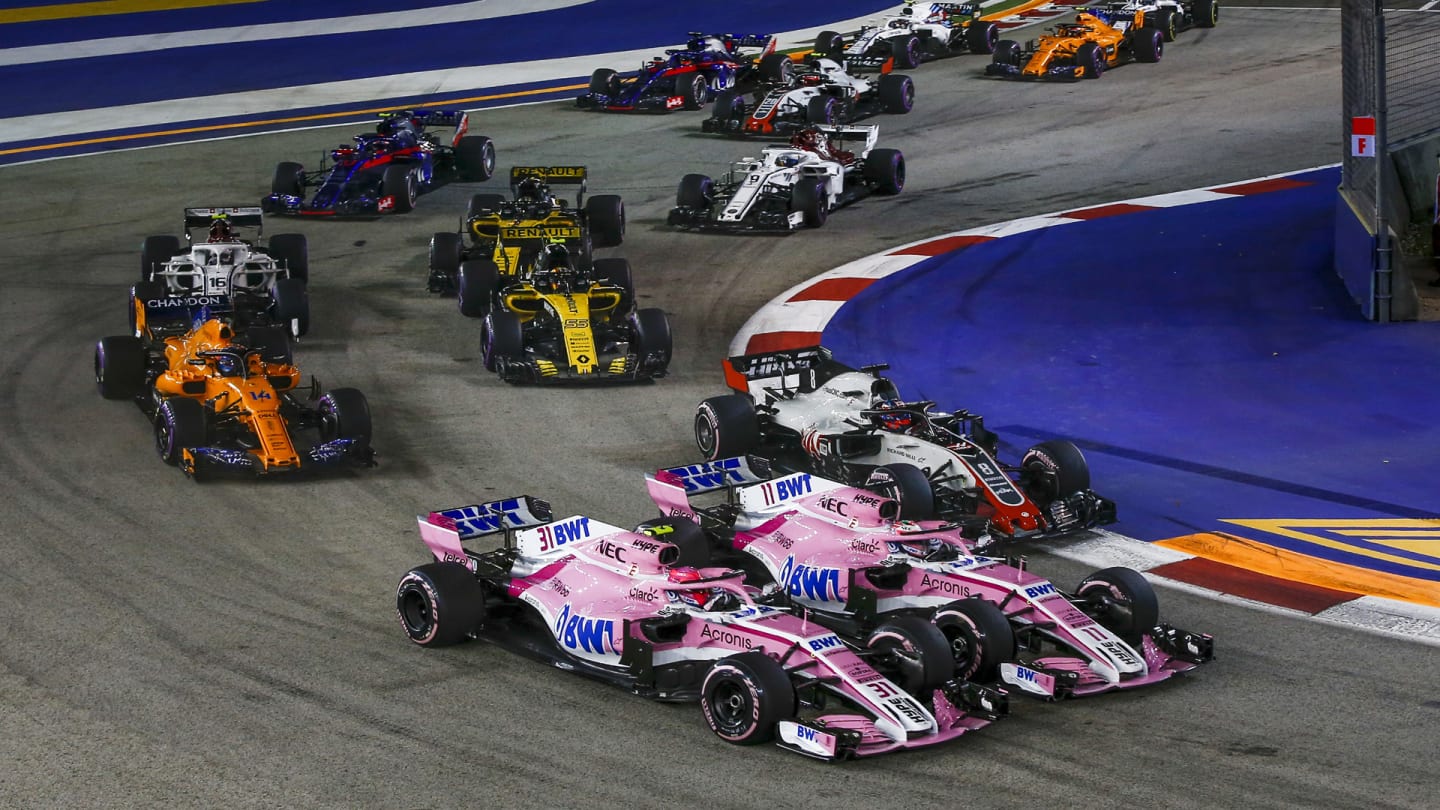 SINGAPORE STREET CIRCUIT, SINGAPORE - SEPTEMBER 16: Esteban Ocon, Racing Point Force India VJM11, Sergio Perez, Racing Point Force India VJM11 and Romain Grosjean, Haas F1 Team VF-18 during the Singapore GP at Singapore Street Circuit on September 16, 2018 in Singapore Street Circuit, Singapore. (Photo by Manuel Goria / Sutton Images)