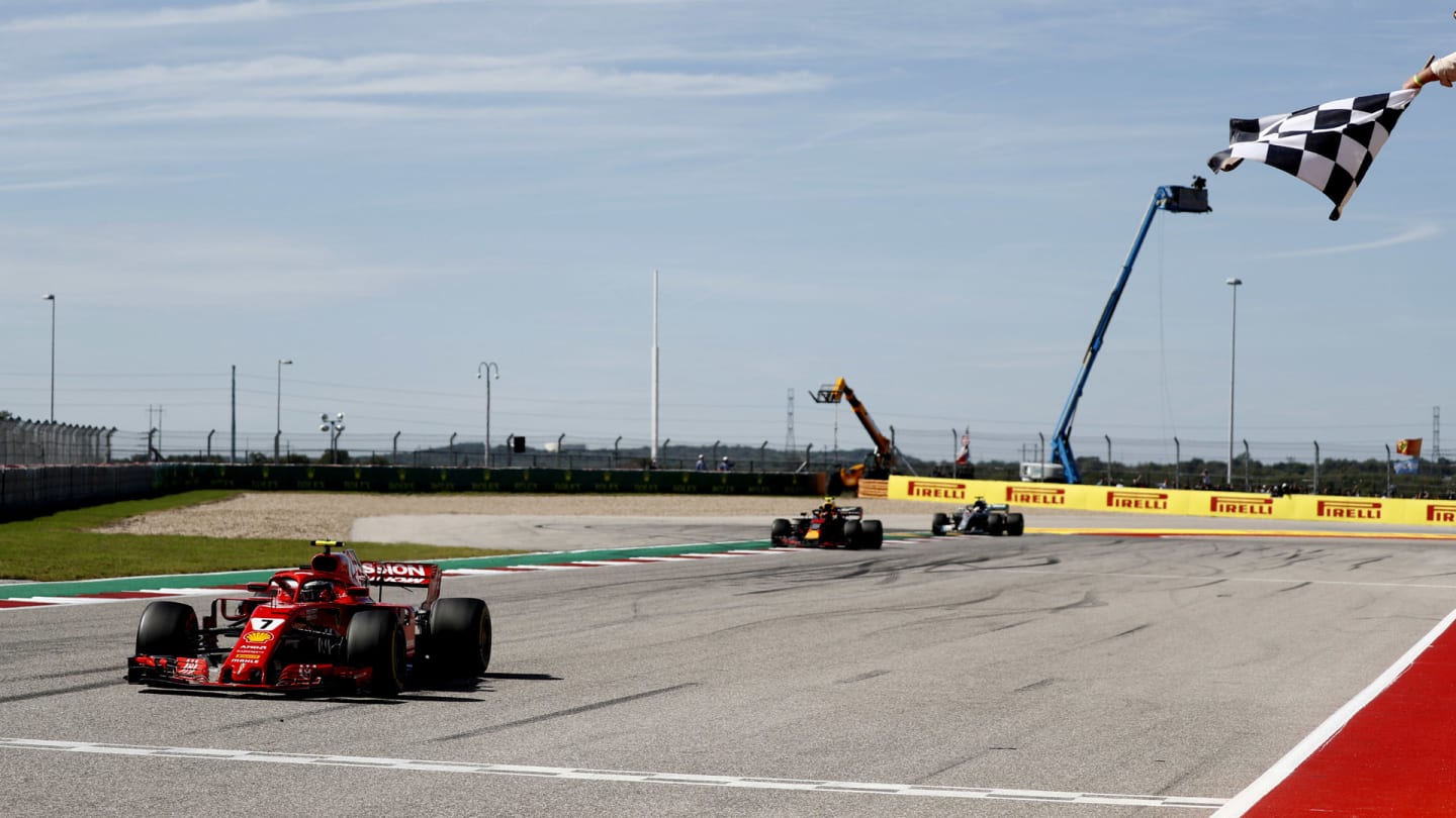 CIRCUIT OF THE AMERICAS, UNITED STATES OF AMERICA - OCTOBER 21: Kimi Raikkonen, Ferrari SF71H, 1st position, takes the chequered flag ahead of Max Verstappen, Red Bull Racing RB14, 2nd position, and Lewis Hamilton, Mercedes AMG F1 W09 EQ Power+, 3rd position during the United States GP at Circuit of the Americas on October 21, 2018 in Circuit of the Americas, United States of America. (Photo by Glenn Dunbar / LAT Images)