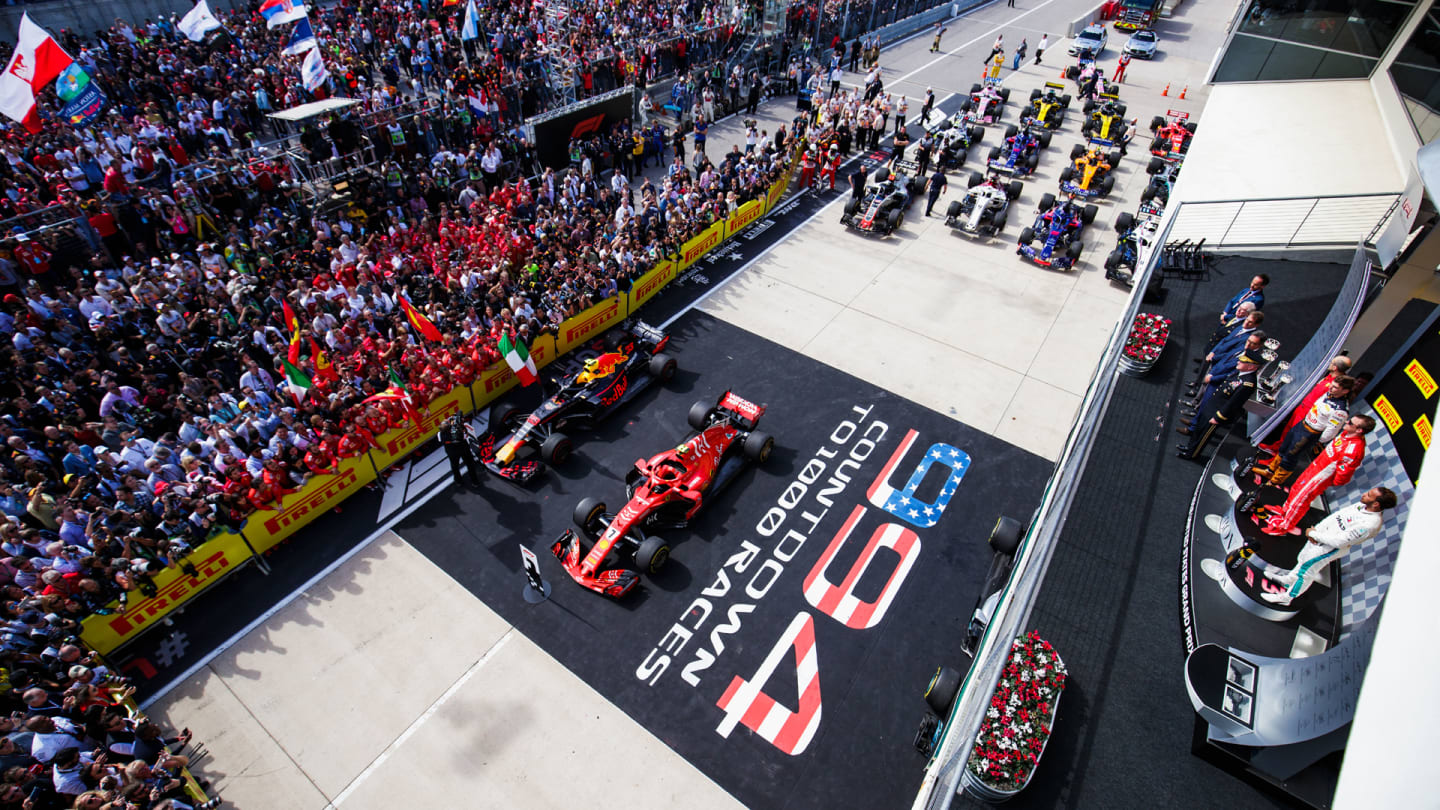 CIRCUIT OF THE AMERICAS, UNITED STATES OF AMERICA - OCTOBER 21: Max Verstappen, Red Bull Racing, 2nd position, Kimi Raikkonen, Ferrari, 1st position, and Lewis Hamilton, Mercedes AMG F1, 3rd position, on the podium during the United States GP at Circuit of the Americas on October 21, 2018 in Circuit of the Americas, United States of America. (Photo by Zak Mauger / LAT Images)