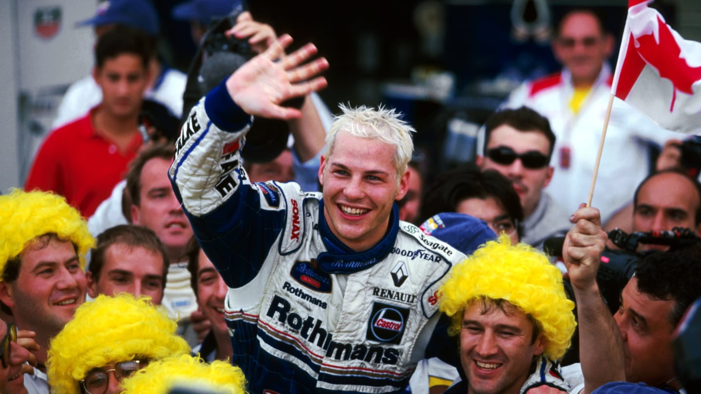 Third placed Jacques Villeneuve (CDN) Williams celebrates becoming the World Champion with the