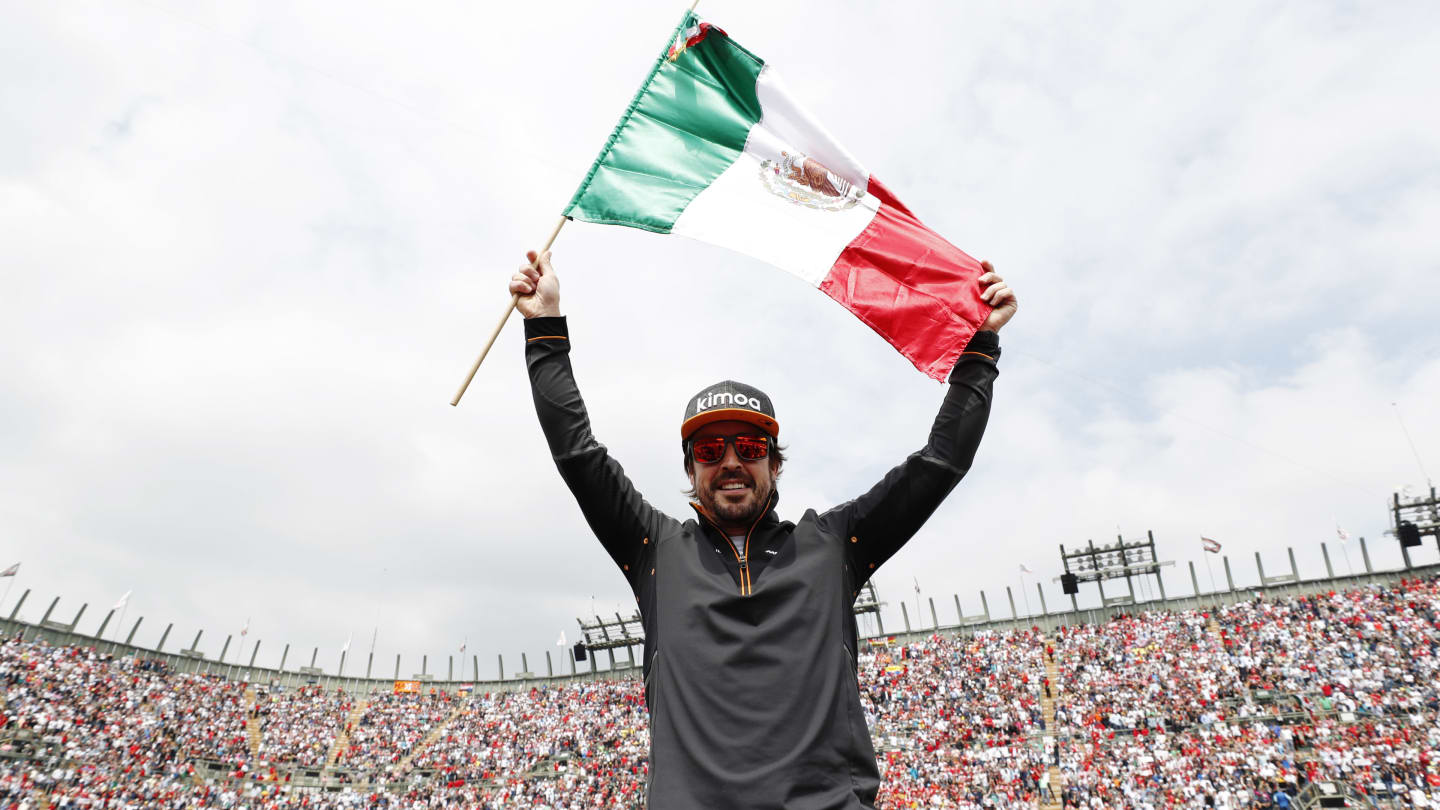 AUTODROMO HERMANOS RODRIGUEZ, MEXICO - OCTOBER 28: Fernando Alonso, McLaren, celebrates with a Mexican flag ahead of the race during the Mexican GP at Autodromo Hermanos Rodriguez on October 28, 2018 in Autodromo Hermanos Rodriguez, Mexico. (Photo by Steven Tee / LAT Images)