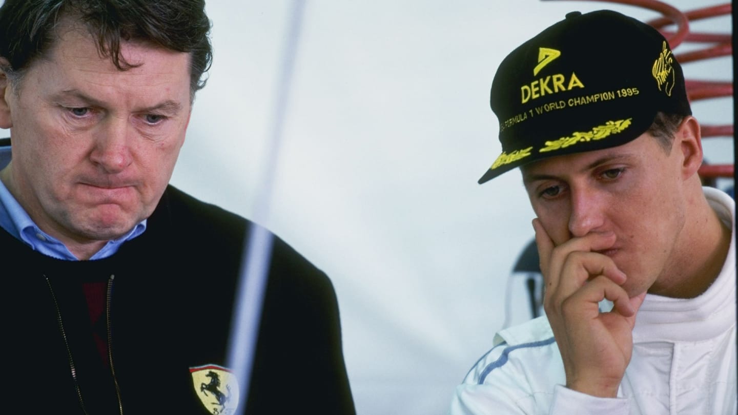 Feb 1996: Michael Schumacher of Germany and the Ferrari team (right) discusses tactics with