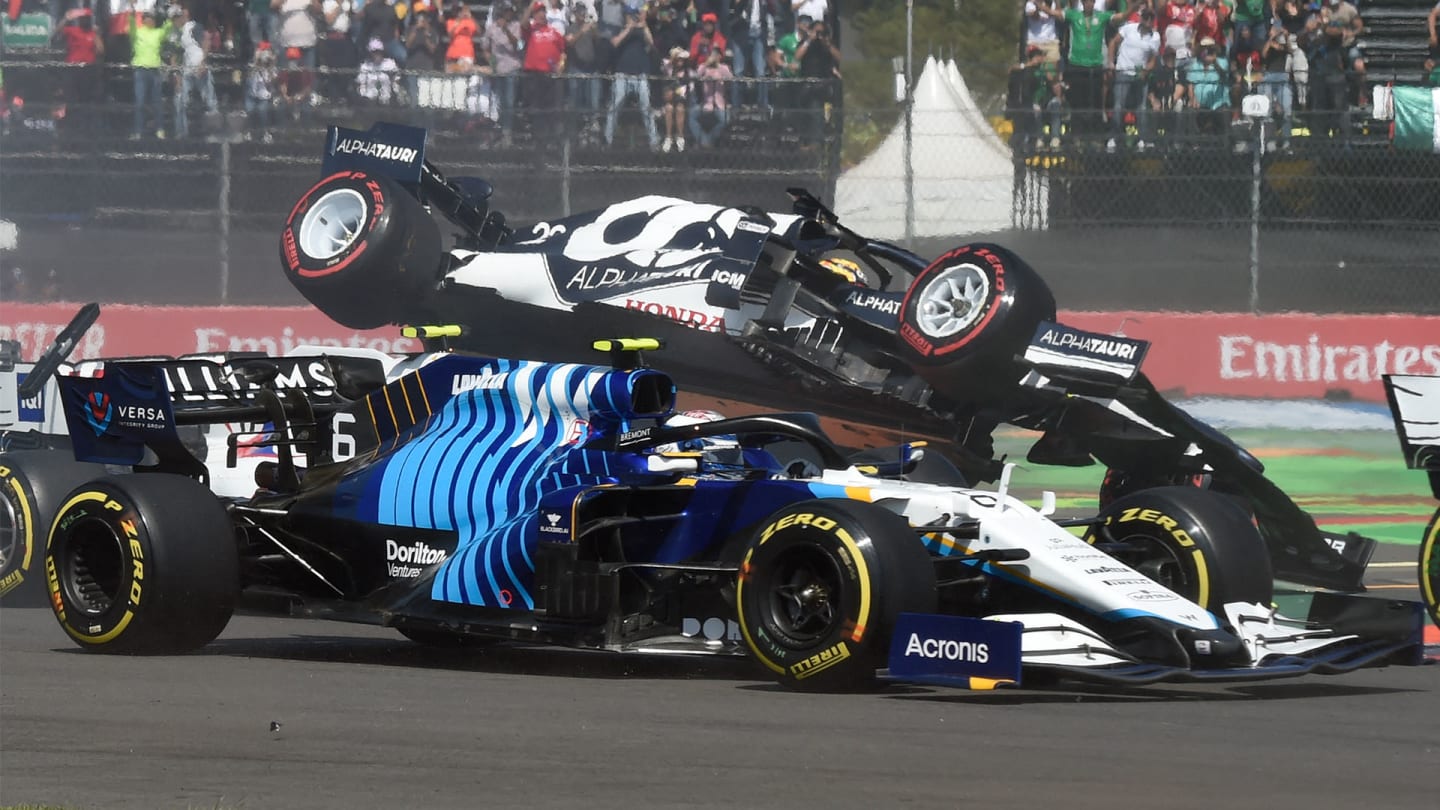 AlphaTauri's Japanese driver Yuki Tsunoda (Top) crashes during the Formula One Mexico Grand Prix at the Hermanos Rodriguez racetrack in Mexico City on November 7, 2021. (Photo by ALFREDO ESTRELLA / AFP) (Photo by ALFREDO ESTRELLA/AFP via Getty Images)