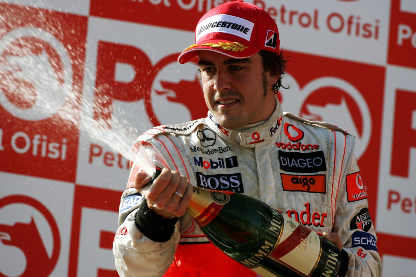 Fernando Alonso (ESP) McLaren celebrates his third position on the podium.
Formula One World