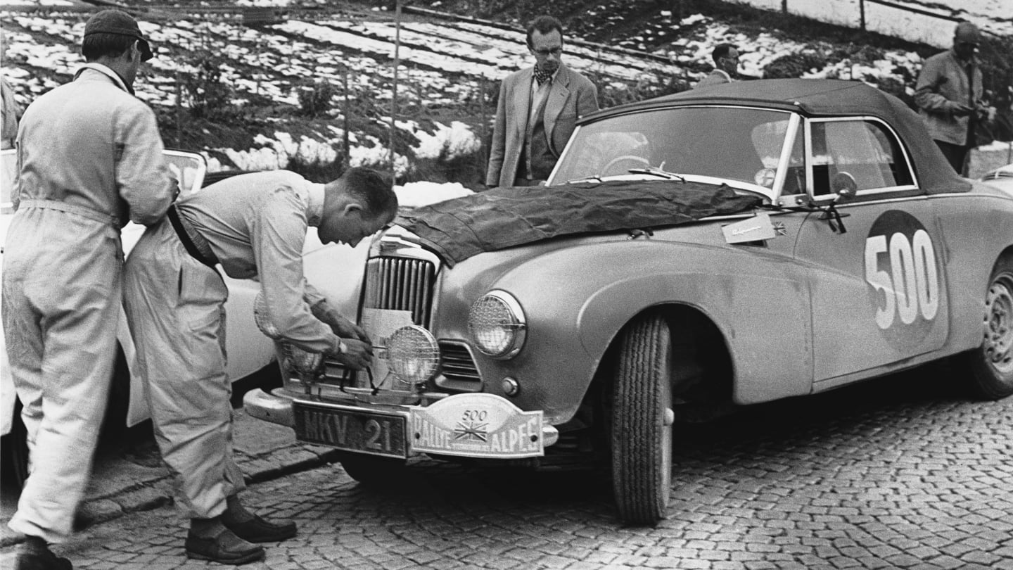 Stirling Moss makes some alterations to his stately Sunbeam-Talbot Alpine during the 1954 Monte Carlo Rally