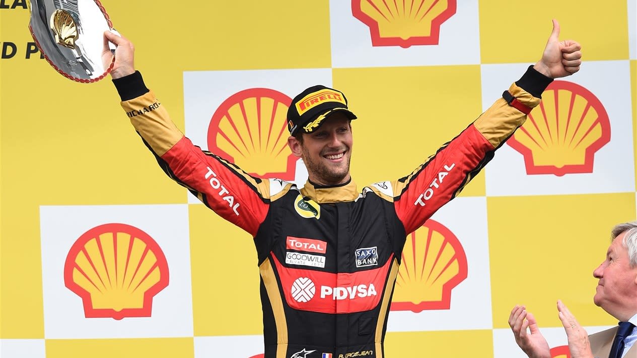 Third placed Romain Grosjean (FRA) Lotus F1 celebrates on the podium with the trophy at Formula One